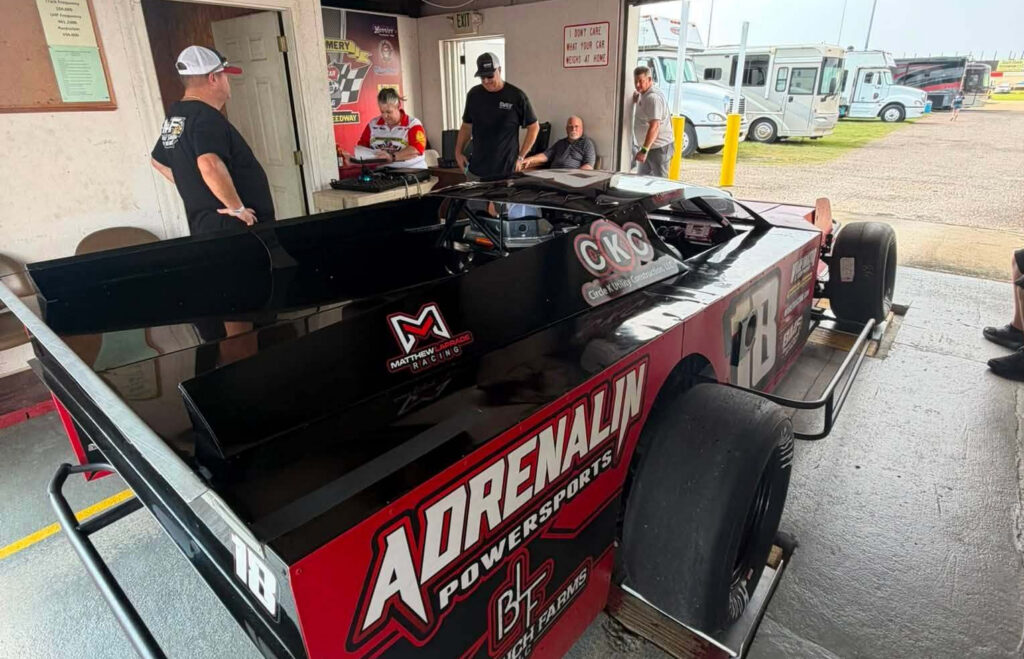 Matthew LaPrade's #18 Modified in the tech shed at Montgomery Motor Speedway
Third parties are visible at the scale desk.
