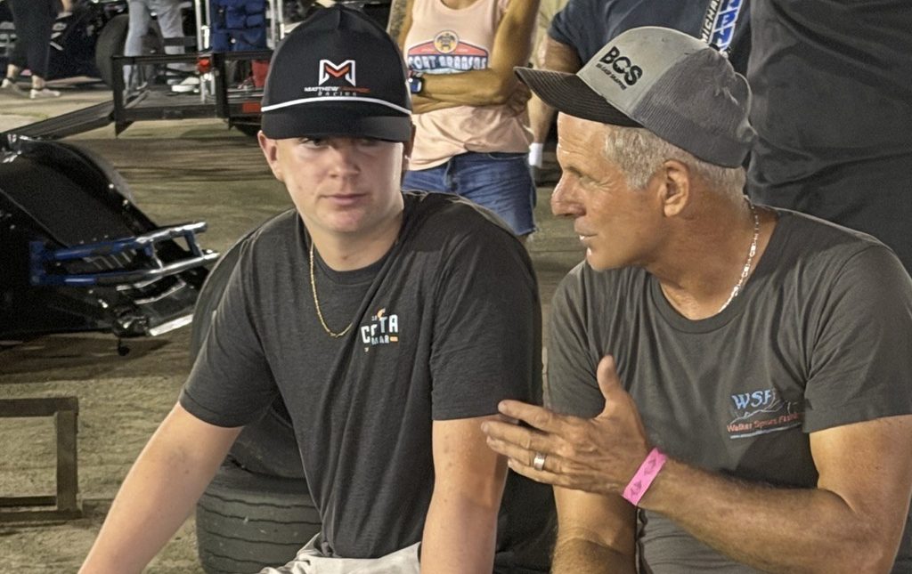 Matthew LaPrade talking with veteran racer Johnny Walker in the pits at Houston Motorsports Park